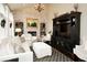 Cozy living room featuring a painted brick fireplace, built-in shelving, and ample seating at 11506 Greenbriar Ln, Parker, CO 80138