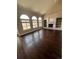 Spacious living room with a brick fireplace, built-in bookshelves, and large windows at 11506 Greenbriar Ln, Parker, CO 80138