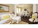 Bright and airy living space with a view into the dining area, hardwood floors, and elegant decor at 11506 Greenbriar Ln, Parker, CO 80138