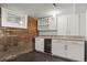 Basement bar with white cabinets, granite counters, and a wine fridge at 3410 Pecos St, Denver, CO 80211