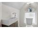 Modern bathroom with vessel sink, waterfall faucet, and a large round mirror at 3410 Pecos St, Denver, CO 80211