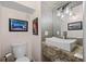 Stylish half-bathroom featuring a modern sink, vessel sink, and decorative mirror at 3410 Pecos St, Denver, CO 80211