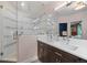 Bright bathroom featuring a double sink vanity, framed mirror and glass enclosed shower at 3410 Pecos St, Denver, CO 80211