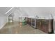 Spacious bonus room with bar area, wine fridge, and gym equipment at 3410 Pecos St, Denver, CO 80211