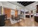 Open concept dining room features a brick wall, modern lighting, and a view of the kitchen at 3410 Pecos St, Denver, CO 80211