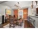 Bright dining room with a brick wall, modern lighting, and wood table at 3410 Pecos St, Denver, CO 80211