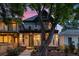 Charming home with a welcoming front porch, elegant columns, and a lush landscaped yard during a beautiful sunset at 3410 Pecos St, Denver, CO 80211