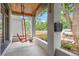 Charming front porch with a unique porch swing, classic mailbox, and beautiful plants at 3410 Pecos St, Denver, CO 80211