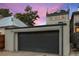 Modern two-car garage with a sleek gray door and updated exterior at 3410 Pecos St, Denver, CO 80211