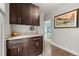 Hallway with dark cabinets and countertop, adjacent to bedroom with soothing colors at 3410 Pecos St, Denver, CO 80211