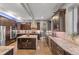 Spacious kitchen boasts dark cabinetry, an island with wine rack, and stainless steel appliances at 3410 Pecos St, Denver, CO 80211