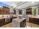 Charming kitchen features an island with granite countertop, dark cabinets, and stainless steel appliances at 3410 Pecos St, Denver, CO 80211