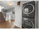 Efficient laundry area with stacked washer and dryer, optimizing space with stylish design near the staircase at 3410 Pecos St, Denver, CO 80211