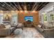 Comfortable living room with exposed brick, a cozy fireplace, and a large screen TV at 3410 Pecos St, Denver, CO 80211