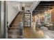 Elegant staircase leading to an open-concept living room with exposed brick and stylish furnishings at 3410 Pecos St, Denver, CO 80211