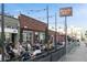 Picture of the outdoor seating area at Highland Tap and Burger, with groups of people dining at 3410 Pecos St, Denver, CO 80211