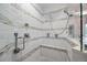 Modern tiled shower with dual shower heads and built-in bench for added comfort and convenience at 3410 Pecos St, Denver, CO 80211