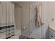 Bathroom with a shower-tub combo and textured shower curtain at 4505 Cholla Trl, Castle Rock, CO 80104