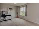 A bright bedroom with a desk, guitar, and a large window overlooking a home at 4505 Cholla Trl, Castle Rock, CO 80104