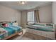 Cozy bedroom featuring twin beds with blue striped bedding and a window at 4505 Cholla Trl, Castle Rock, CO 80104