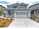 Charming two-story home featuring a two-car garage, manicured lawn, and inviting front porch with blue shutters at 4505 Cholla Trl, Castle Rock, CO 80104