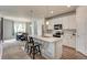 Bright kitchen with white cabinets, stainless steel appliances, island, and dining area at 4505 Cholla Trl, Castle Rock, CO 80104