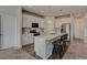 Modern kitchen with white cabinets, stainless steel appliances, and a center island with breakfast bar at 4505 Cholla Trl, Castle Rock, CO 80104