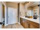 Modern bathroom with double vanity, wood cabinets, quartz countertop and a closet with white sliding doors at 13794 Honey Hush Trl, Parker, CO 80134