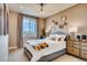 Cozy bedroom featuring a comfortable bed, stylish decor and a window with natural light at 13794 Honey Hush Trl, Parker, CO 80134