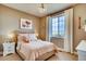 Charming bedroom with plush bed, soft lighting, a decorative pillow and a view to the outside at 13794 Honey Hush Trl, Parker, CO 80134