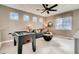 Inviting game room with foosball table, comfortable seating, and plenty of natural light at 13794 Honey Hush Trl, Parker, CO 80134