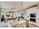 Open-concept kitchen with granite countertops, stainless steel appliances, and a view of the dining and living areas at 13794 Honey Hush Trl, Parker, CO 80134