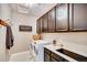 Functional laundry room featuring a washer and dryer, dark cabinets, and storage space at 13794 Honey Hush Trl, Parker, CO 80134