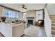 Cozy living room features a brick fireplace, comfortable seating, and natural light from a large window at 13794 Honey Hush Trl, Parker, CO 80134