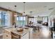 Bright and airy living space with large windows, a fireplace, and an open flow to the dining and kitchen areas at 13794 Honey Hush Trl, Parker, CO 80134