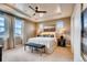 Serene main bedroom with a tray ceiling, soft lighting, and a large window offering ample natural light at 13794 Honey Hush Trl, Parker, CO 80134
