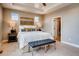 Comfortable main bedroom with a king-size bed, side tables, and a view of the en-suite bathroom at 13794 Honey Hush Trl, Parker, CO 80134