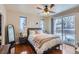 Comfortable bedroom with a ceiling fan, wood floors, and a sliding glass door with balcony access at 4500 Baseline Rd # 3101, Boulder, CO 80303