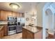 Updated kitchen with stainless steel appliances and granite countertops on a kitchen island at 4500 Baseline Rd # 3101, Boulder, CO 80303