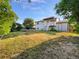 Expansive backyard with a deck, a covered patio, mature trees, and a well-manicured lawn at 12238 Monroe Dr, Thornton, CO 80241