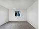 Bright bedroom with neutral carpet, fresh white walls, and a window providing natural light at 12238 Monroe Dr, Thornton, CO 80241