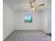 Bright and airy bedroom with a ceiling fan, neutral carpet, and a large window at 12238 Monroe Dr, Thornton, CO 80241