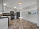 Well-lit kitchen with white cabinetry, black appliances, and a tiled floor at 12238 Monroe Dr, Thornton, CO 80241