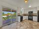 Eat-in kitchen with a sliding glass door that opens to a deck, and white cabinetry at 12238 Monroe Dr, Thornton, CO 80241