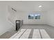 Clean, sunlit living room with neutral carpet, modern staircase, and large windows at 12238 Monroe Dr, Thornton, CO 80241