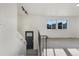 Bright and airy room featuring staircase with iron railing, large windows and neutral carpeting at 12238 Monroe Dr, Thornton, CO 80241