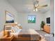 Cozy staged bedroom featuring a neutral color scheme, ceiling fan, and view to the outdoors at 12238 Monroe Dr, Thornton, CO 80241