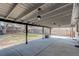 Covered backyard patio with concrete flooring, a spacious yard, and a privacy fence at 2202 S Grape St, Denver, CO 80222