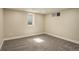 Finished basement bedroom with carpet flooring and a large window for natural light at 2202 S Grape St, Denver, CO 80222