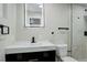Modern bathroom features a stylish vanity with a white marble countertop and a sleek, black faucet at 2202 S Grape St, Denver, CO 80222